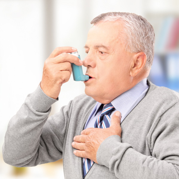 Man with asthma inhaler.
